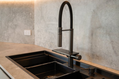 Modern kitchen scene featuring the ALIA Smart Sink with dual bowls, progressive 360° rotating pull-out mixer tap, and waterfall function for advanced usability and style.
