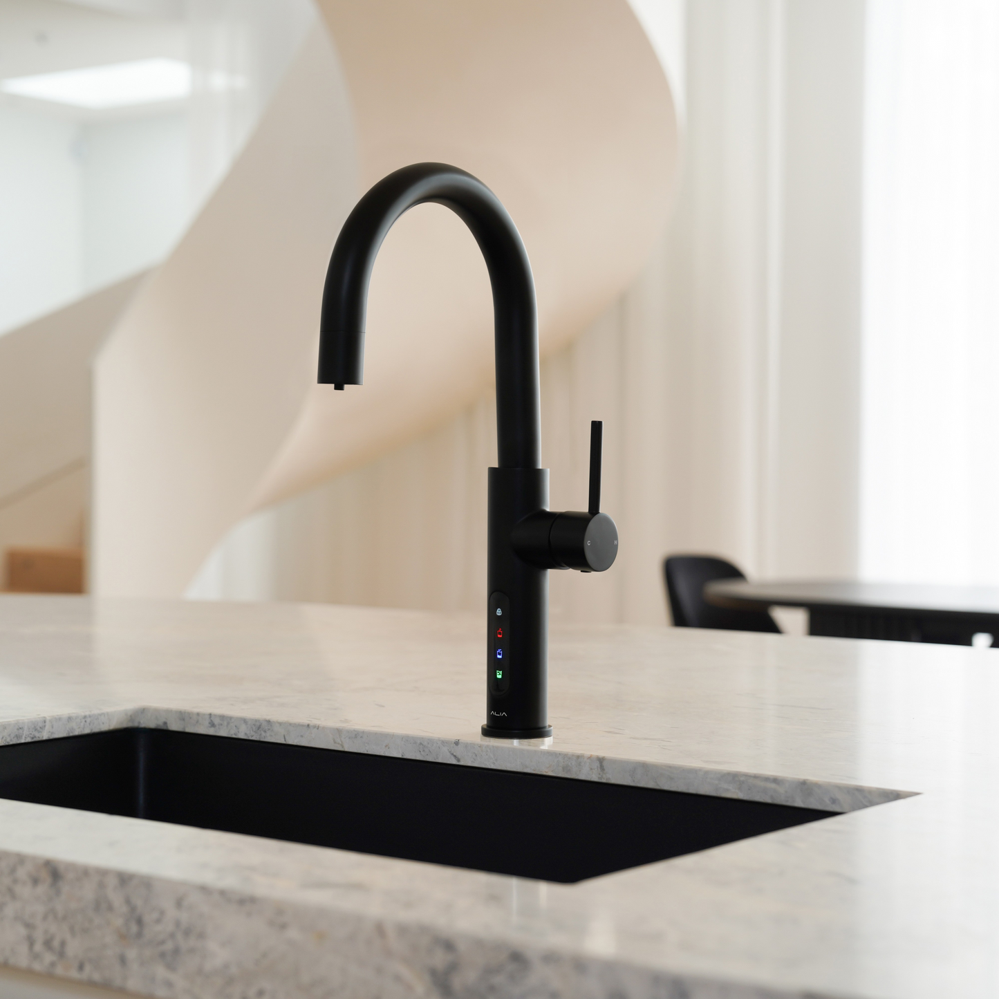 Alia X51 instant hot, cold, and sparkling filtered water tap in matte black accenting a luxury kitchen, highlighting its premium filtered water and bold contemporary design.
